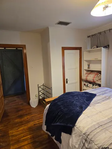 a bedroom with a bed and a closet