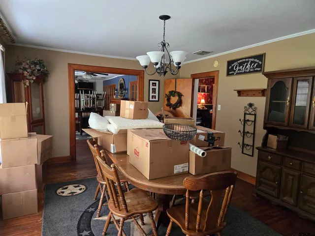 a view of a dining room with furniture and chandelier