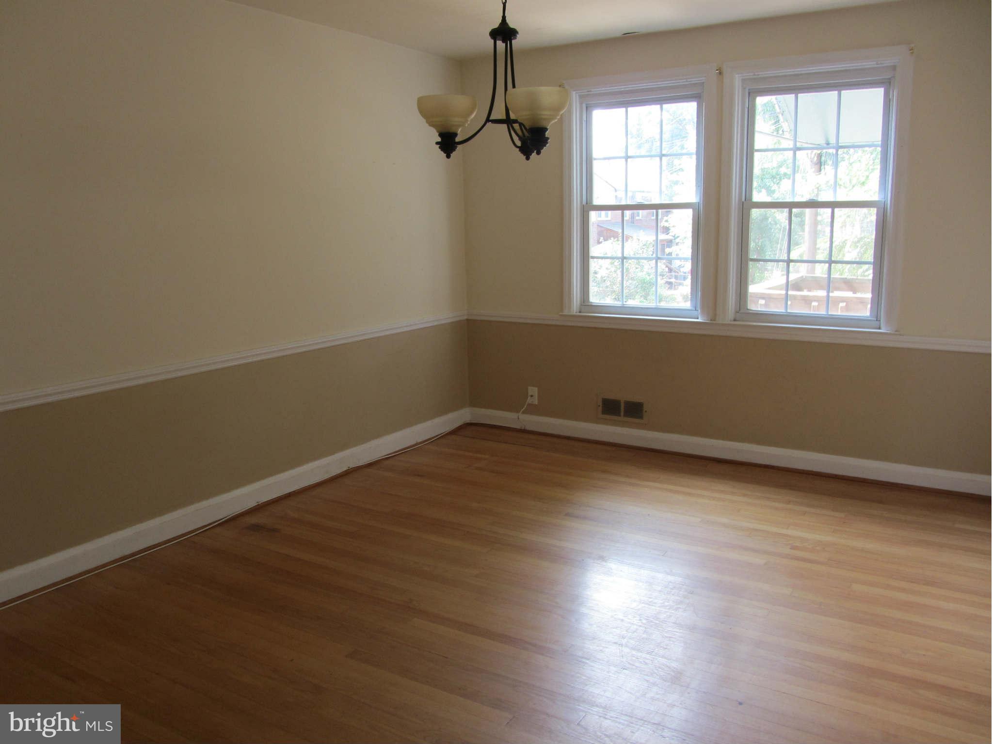 508 Academy Road Baltimore, MD 21228 - Photo 2 of 11 Dining Room with Hardwood Flooring & Chair Railing