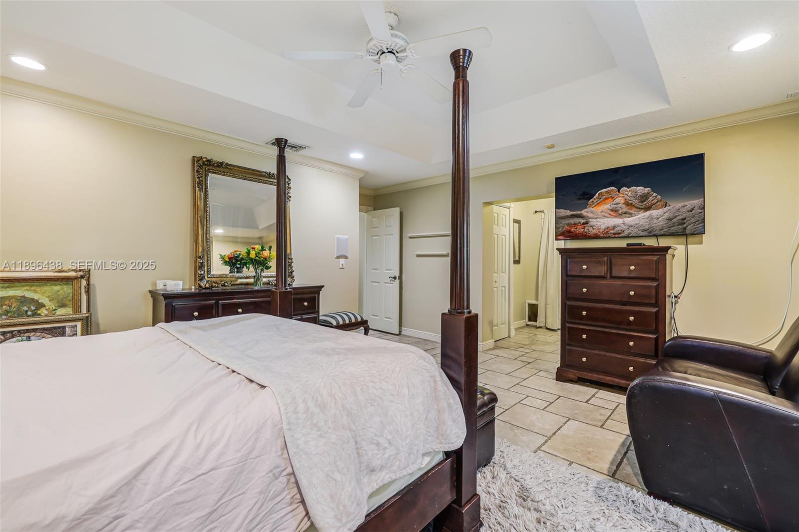 10101 Southwest 5th Street Plantation, FL 33324 - Photo 32 of 77 a bedroom with a bed a dresser and flowerpot