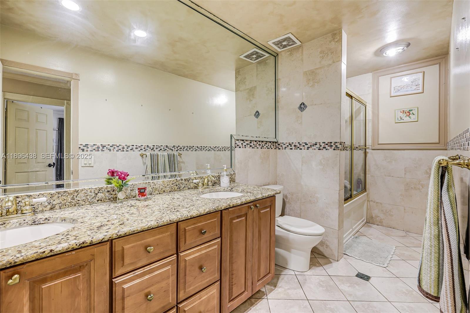 10101 Southwest 5th Street Plantation, FL 33324 - Photo 45 of 77 a bathroom with a granite countertop sink toilet and shower