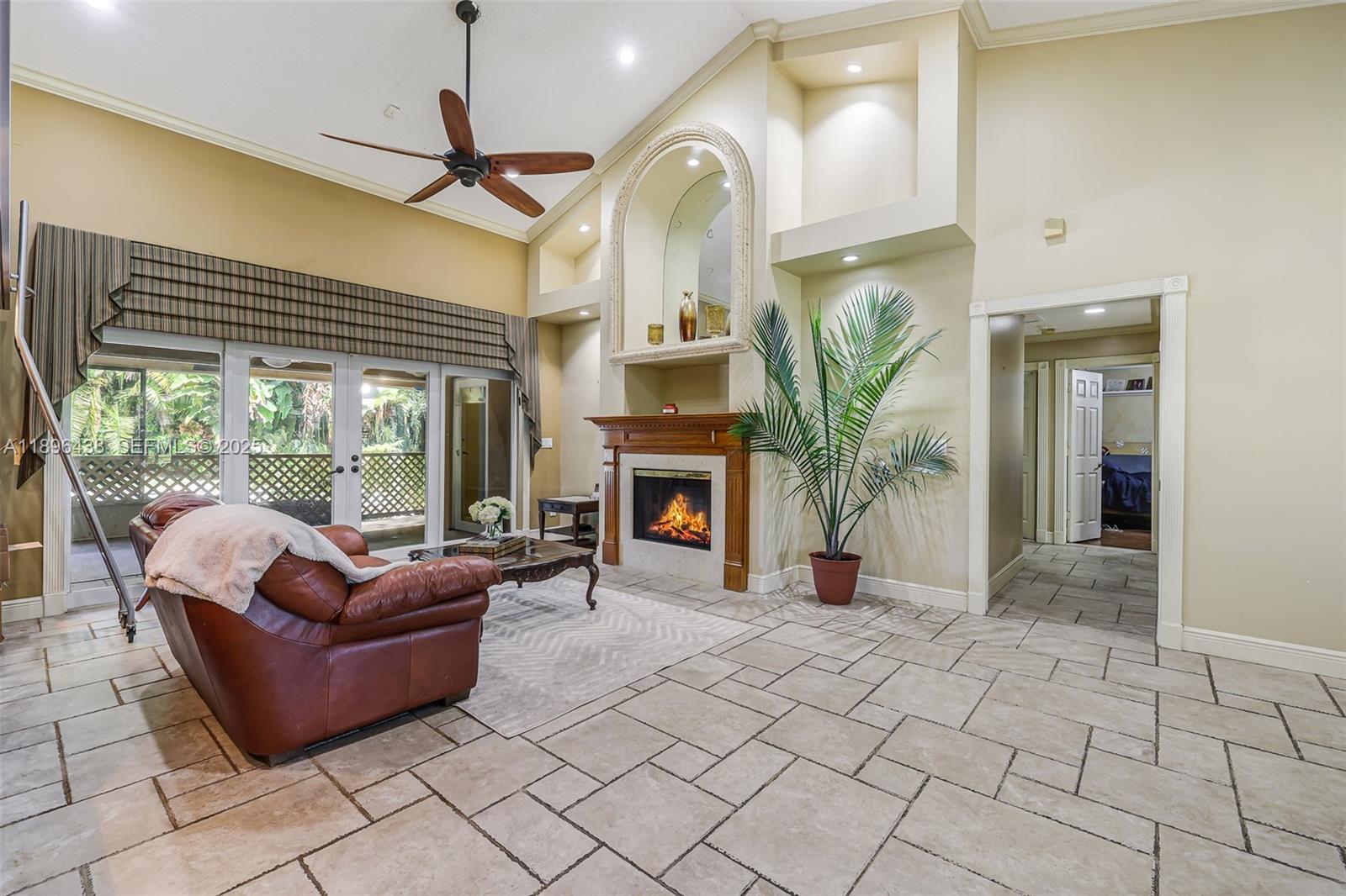 10101 Southwest 5th Street Plantation, FL 33324 - Photo 7 of 77 a living room with furniture a fireplace and a chandelier