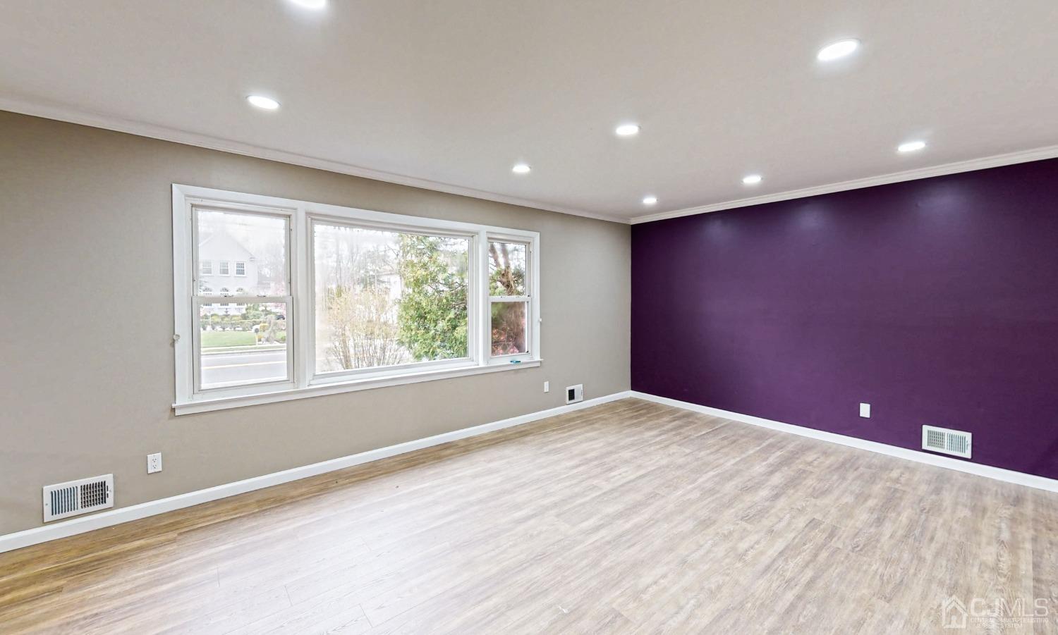 418 Plainfield Road Edison, NJ 08820 - Photo 7 of 45 a view of an empty room with wooden floor and a window