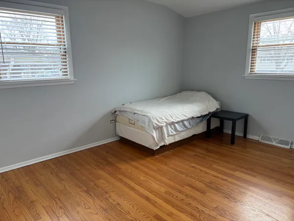 a spacious bedroom with a bed and a window