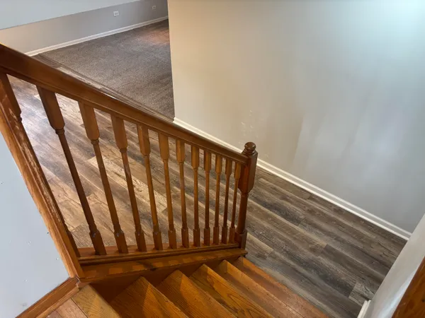 a view of staircase with wooden floor