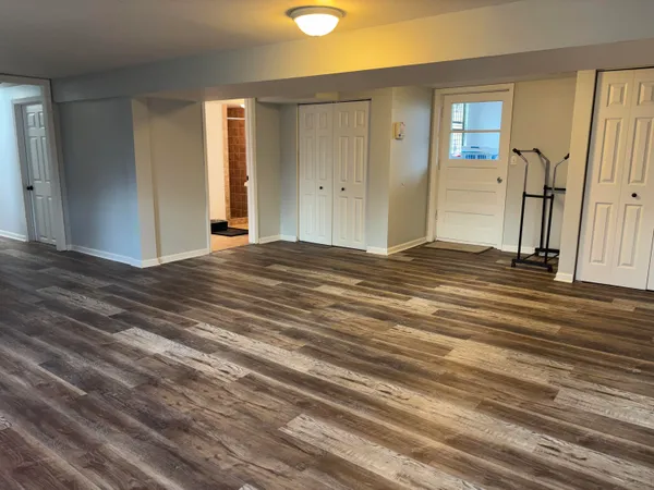 a view of a livingroom with wooden floor and window