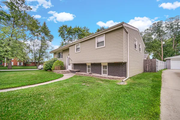 a front view of house with yard and green space
