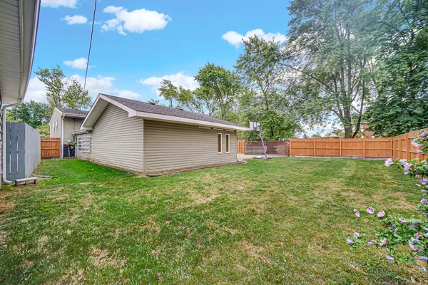 a backyard of a house with plants and entertaining space