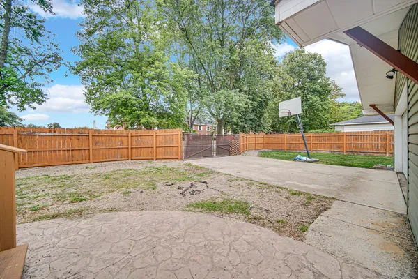 a view of a backyard with wooden fence