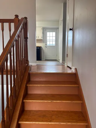 a view of entryway and hall with wooden floor