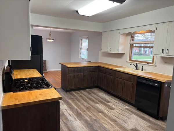 a kitchen with stainless steel appliances a sink stove and cabinets