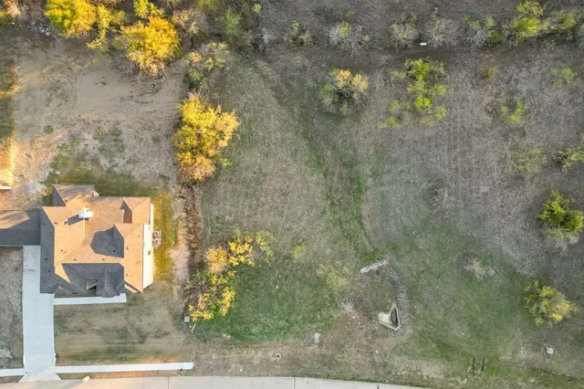 a vase of flowers sitting on a floor