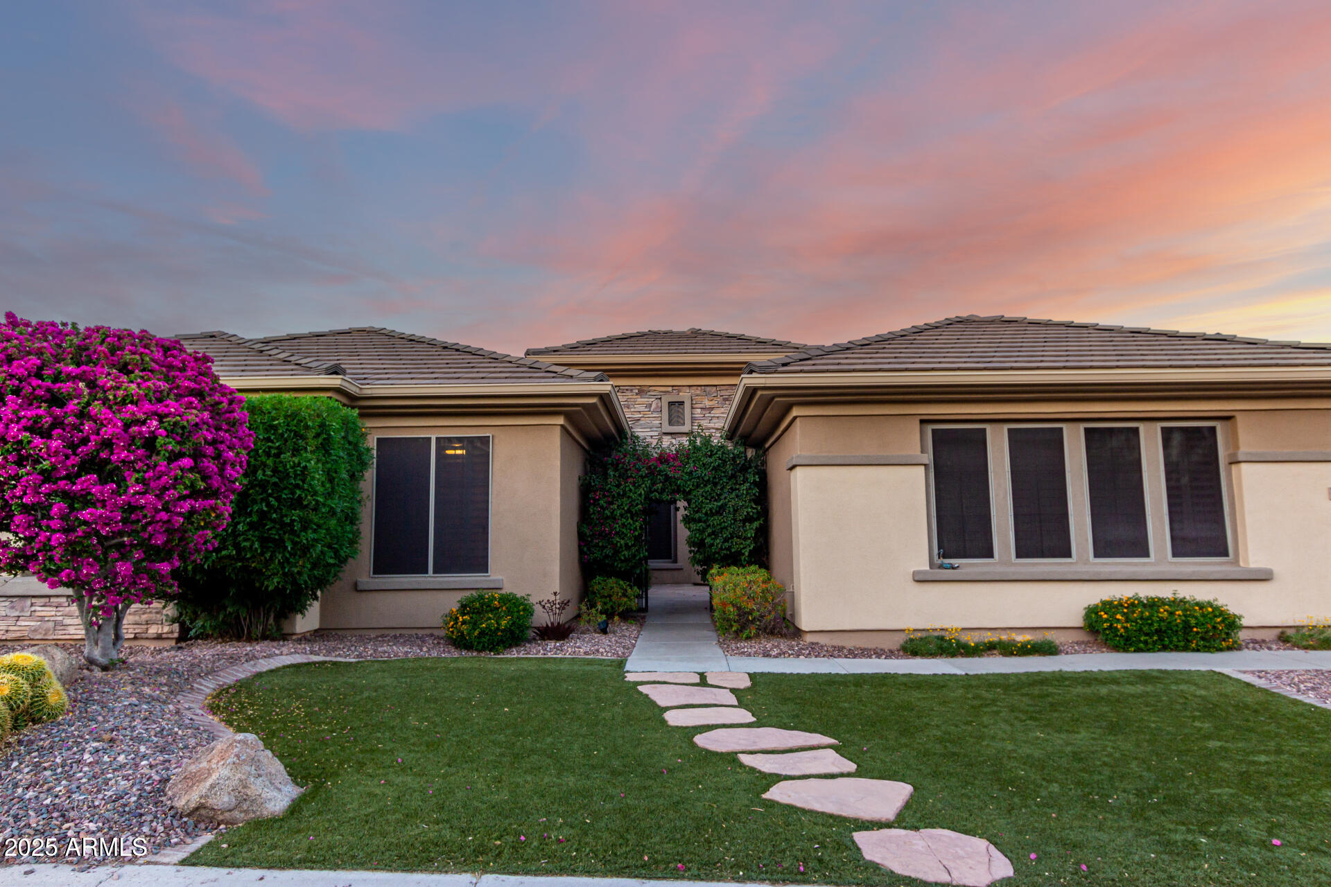 41715 North River Bend Road Phoenix, AZ 85086 - Photo 2 of 60 a front view of a house with a garden and plants