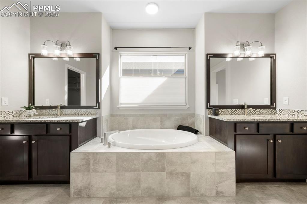 1073 Native Dancer Terrace Colorado Springs, CO 80921 - Photo 25 of 48 Bathroom with two vanities and a bath