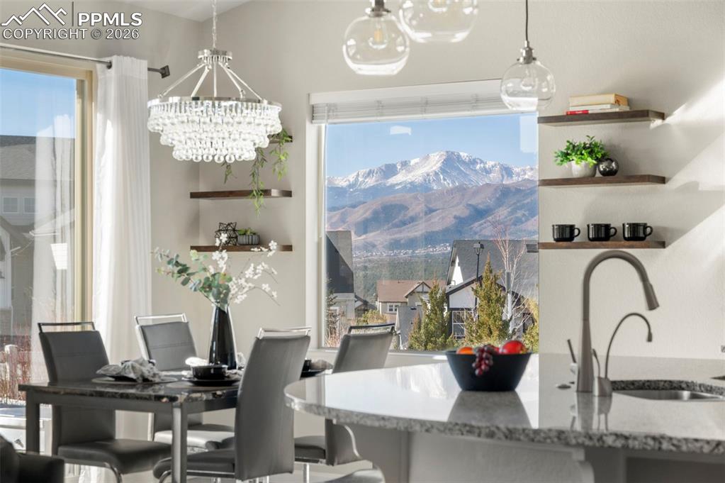 1073 Native Dancer Terrace Colorado Springs, CO 80921 - Photo 3 of 48 Dining room with hanging lights and a mountain view