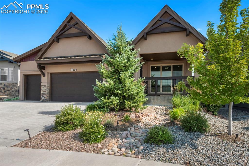 1073 Native Dancer Terrace Colorado Springs, CO 80921 - Photo 6 of 48 Craftsman inspired home with stucco siding, a garage, driveway, and stone siding