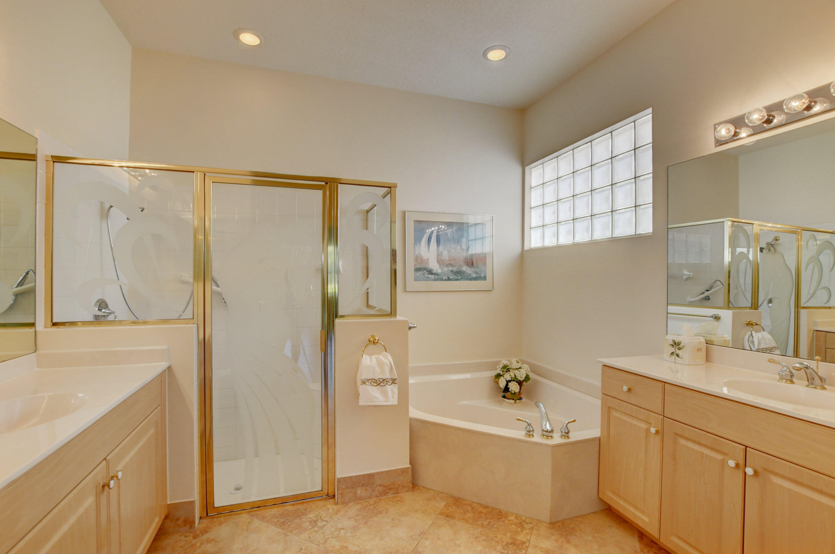 7097 Haviland Circle Boynton Beach, FL 33437 - Photo 16 of 72 a bathroom with a tub a sink a mirror and a shower