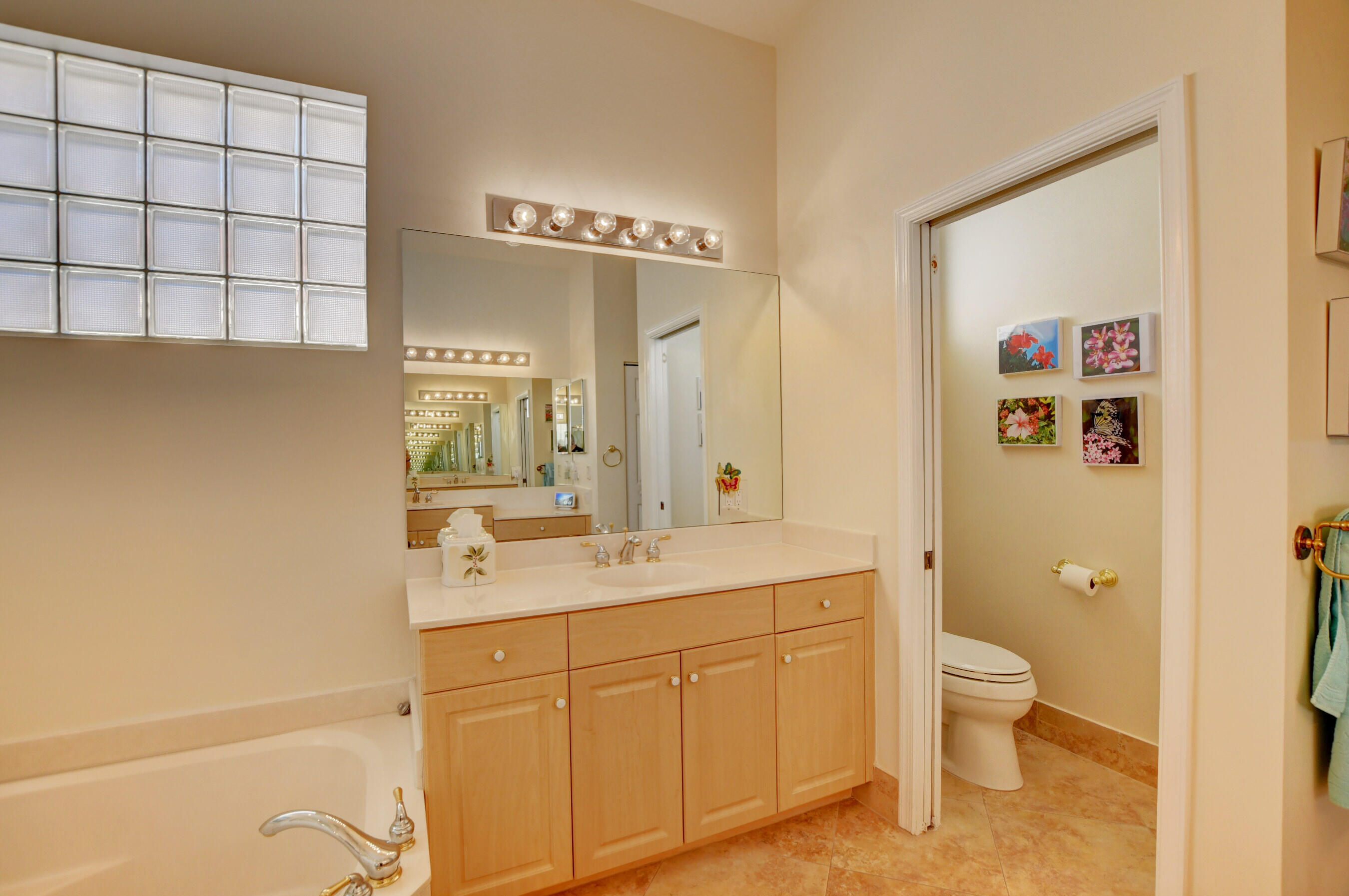 7097 Haviland Circle Boynton Beach, FL 33437 - Photo 18 of 72 a spacious bathroom with a granite countertop sink a toilet and a shower