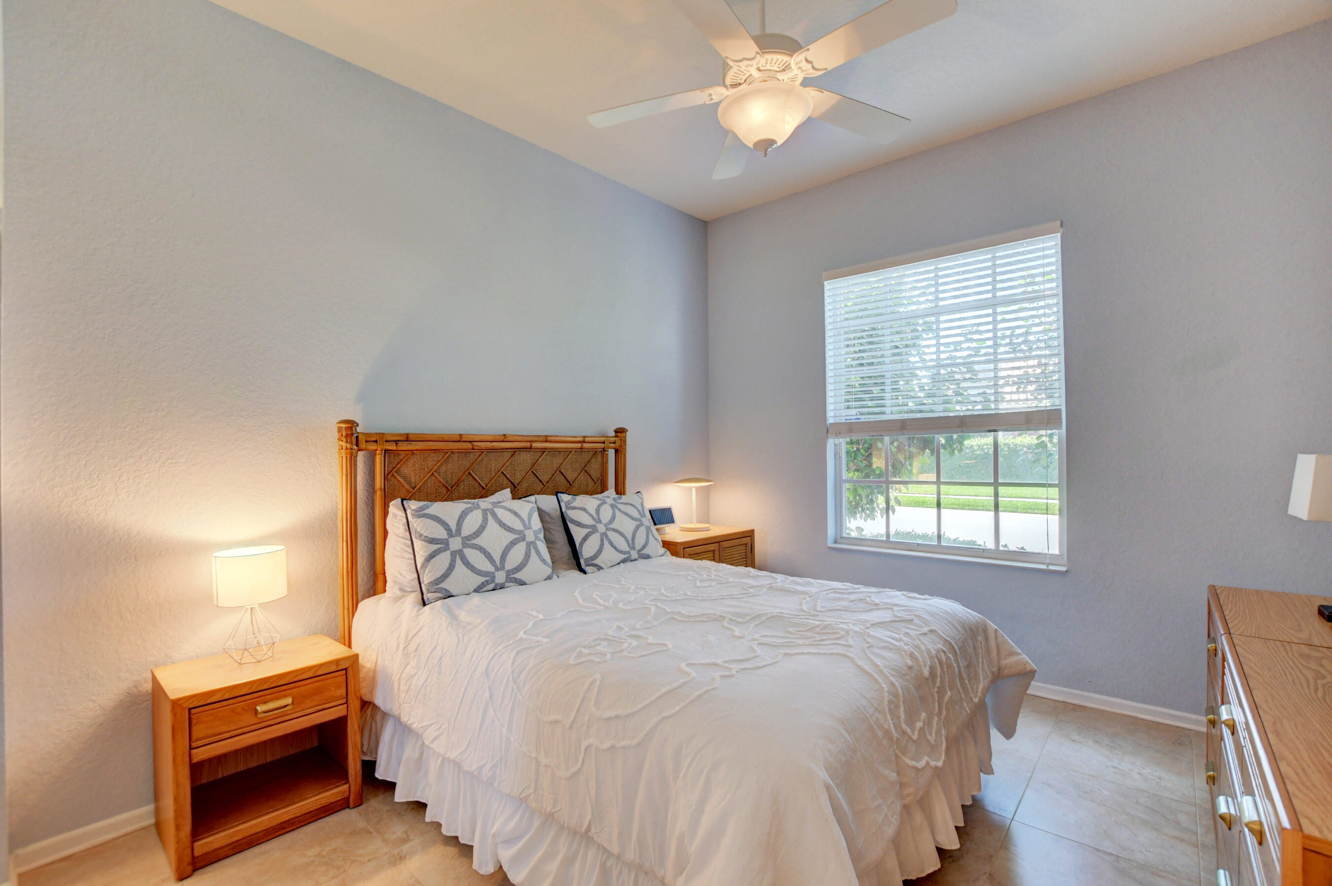 7097 Haviland Circle Boynton Beach, FL 33437 - Photo 19 of 72 a bedroom with a bed and a window