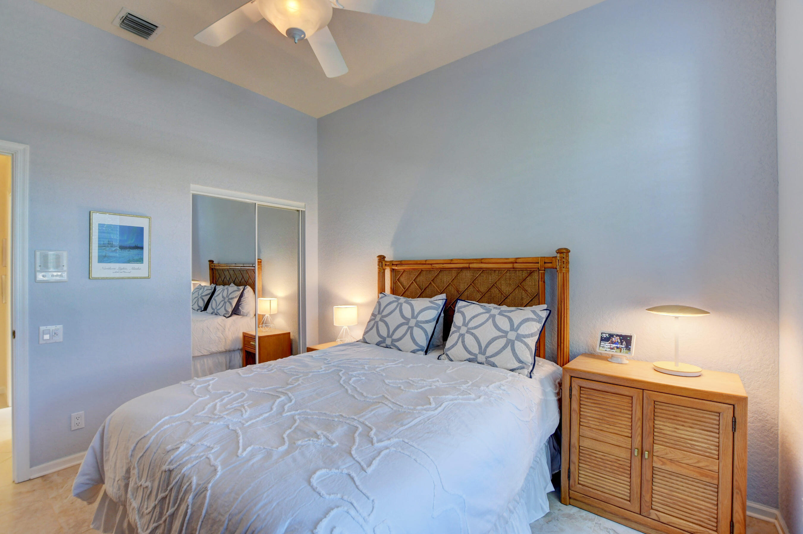 7097 Haviland Circle Boynton Beach, FL 33437 - Photo 20 of 72 a bedroom with a bed and a lamp on dresser