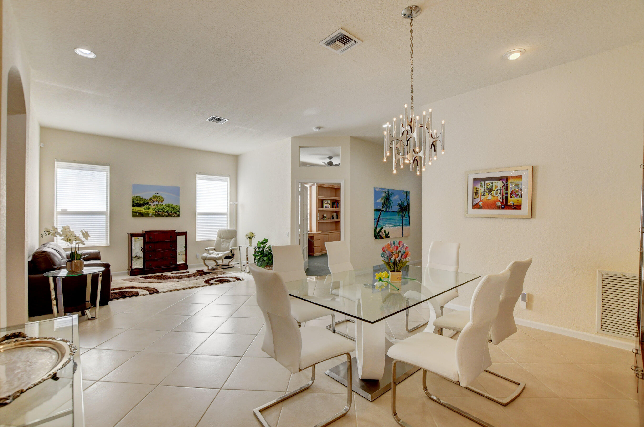 7097 Haviland Circle Boynton Beach, FL 33437 - Photo 29 of 72 a view of a dining room with furniture wooden floor and chandelier