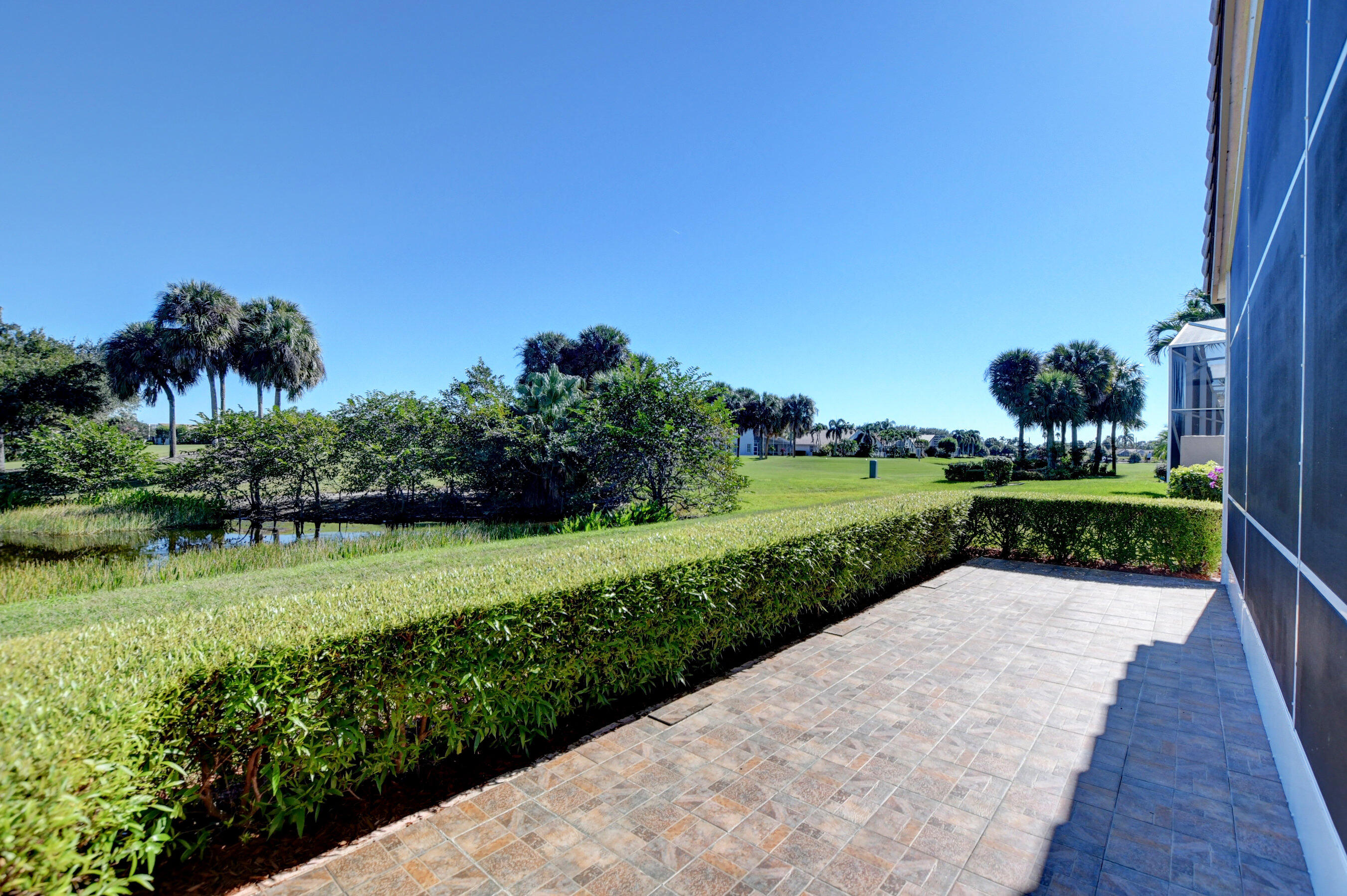 7097 Haviland Circle Boynton Beach, FL 33437 - Photo 37 of 72 a view of a garden with a lake