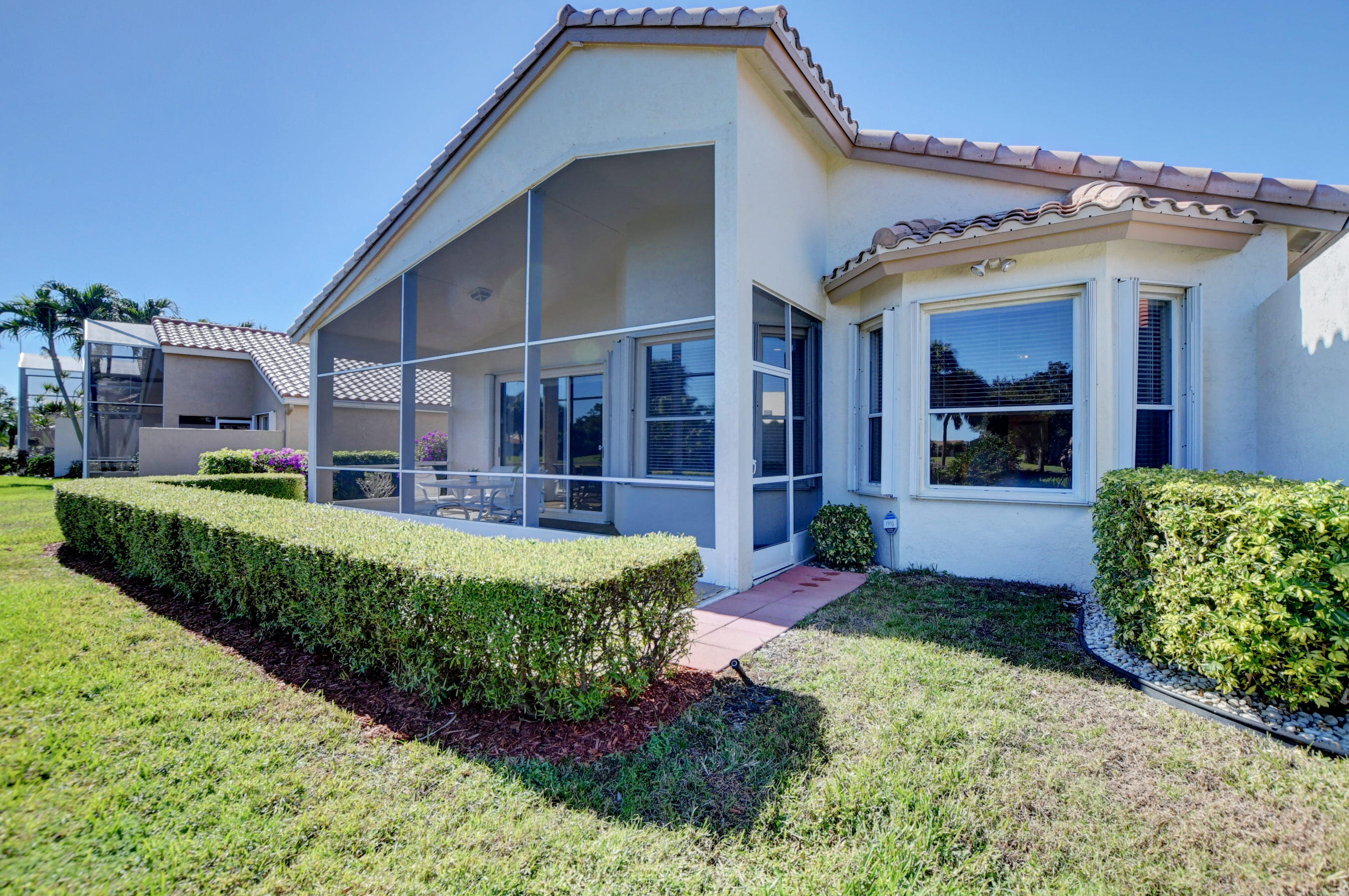 7097 Haviland Circle Boynton Beach, FL 33437 - Photo 41 of 72 a front view of a house with a yard