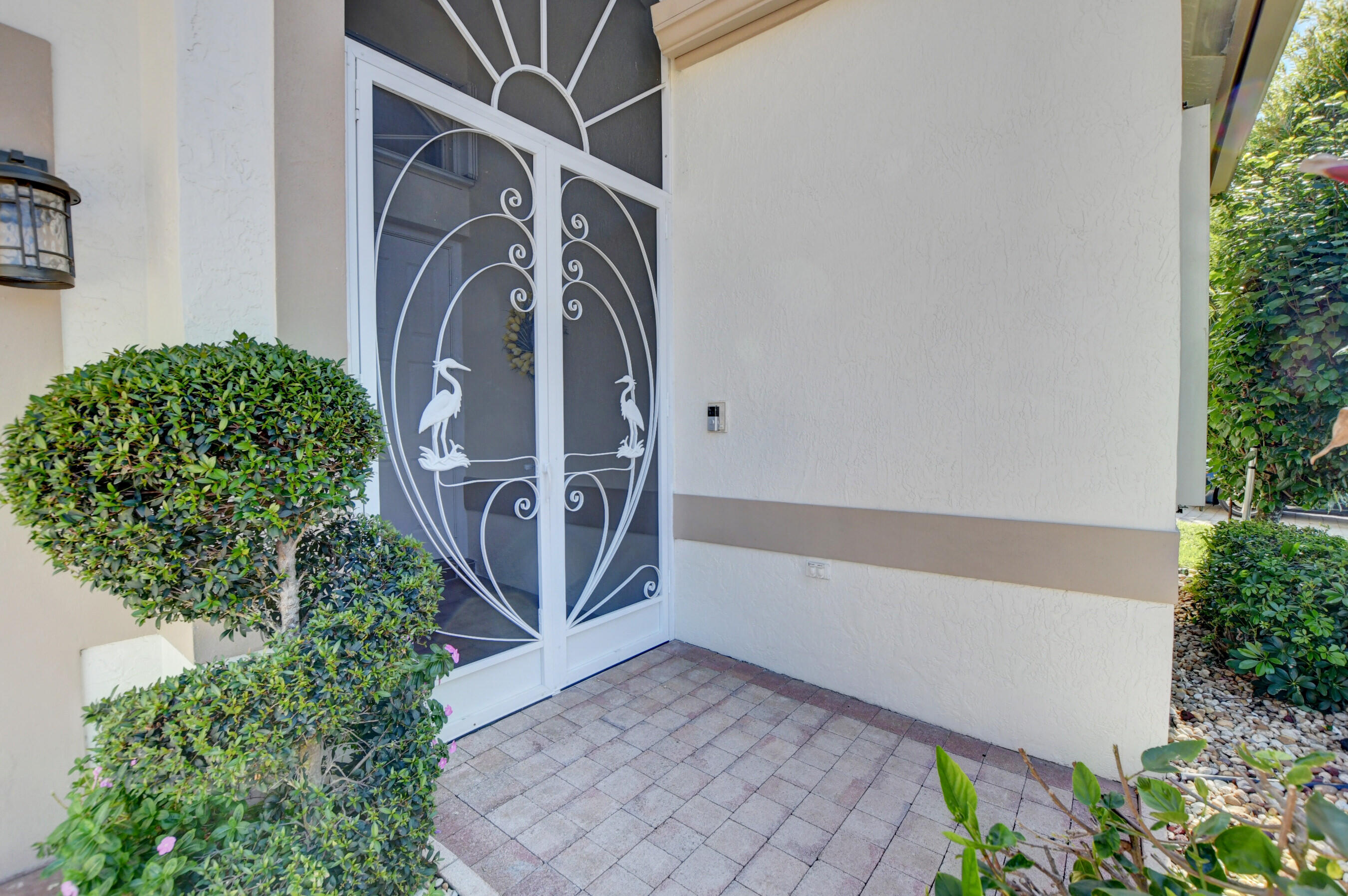 7097 Haviland Circle Boynton Beach, FL 33437 - Photo 42 of 72 a view of a door with a potted plant