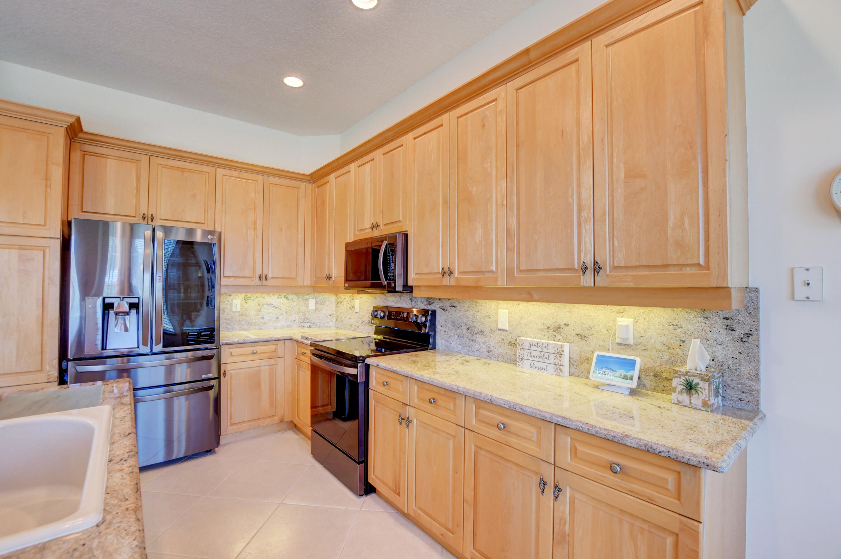 7097 Haviland Circle Boynton Beach, FL 33437 - Photo 7 of 72 a kitchen with stainless steel appliances a refrigerator sink and cabinets