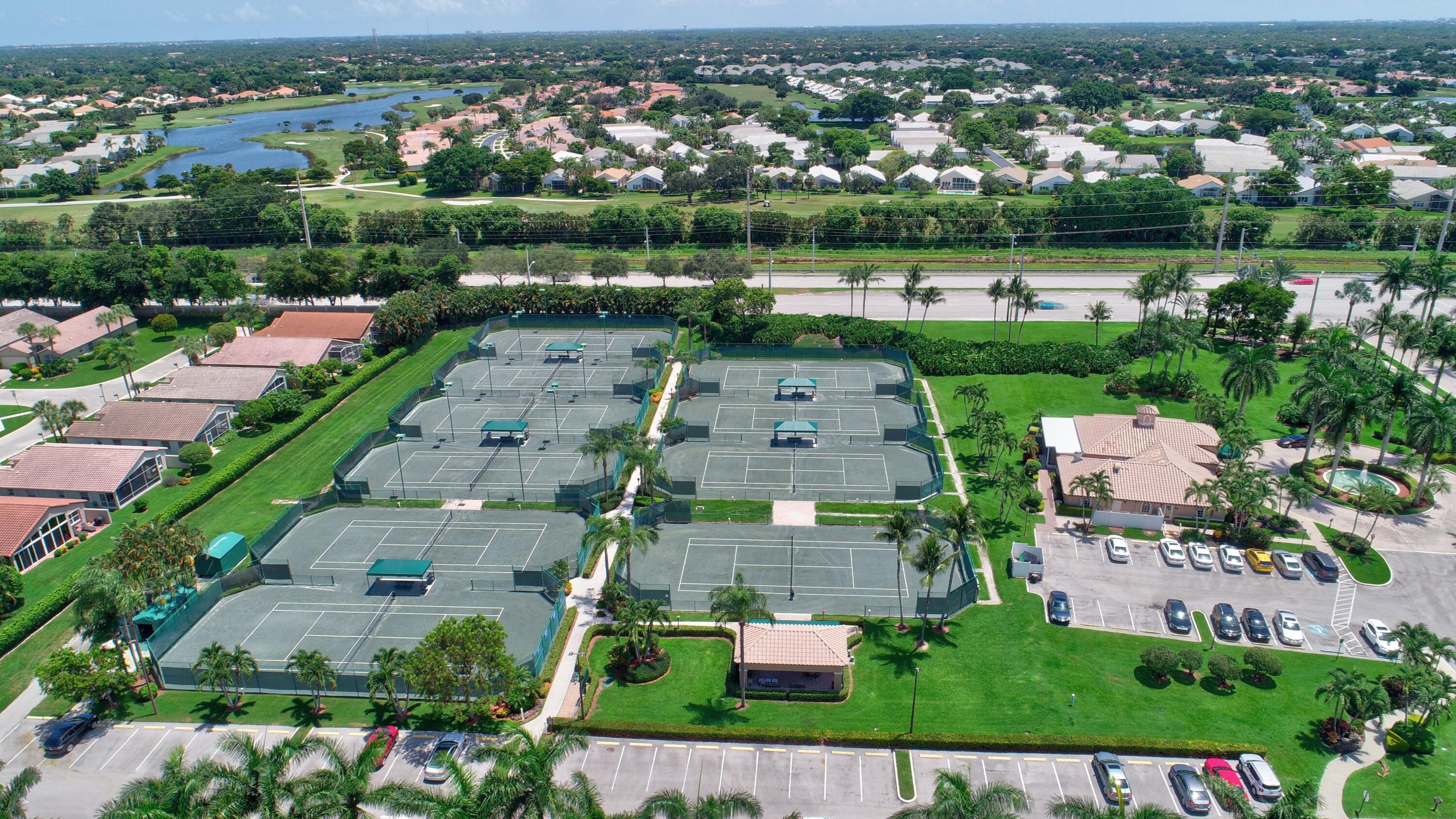 7097 Haviland Circle Boynton Beach, FL 33437 - Photo 61 of 72 an aerial view of a house with a garden and lake view