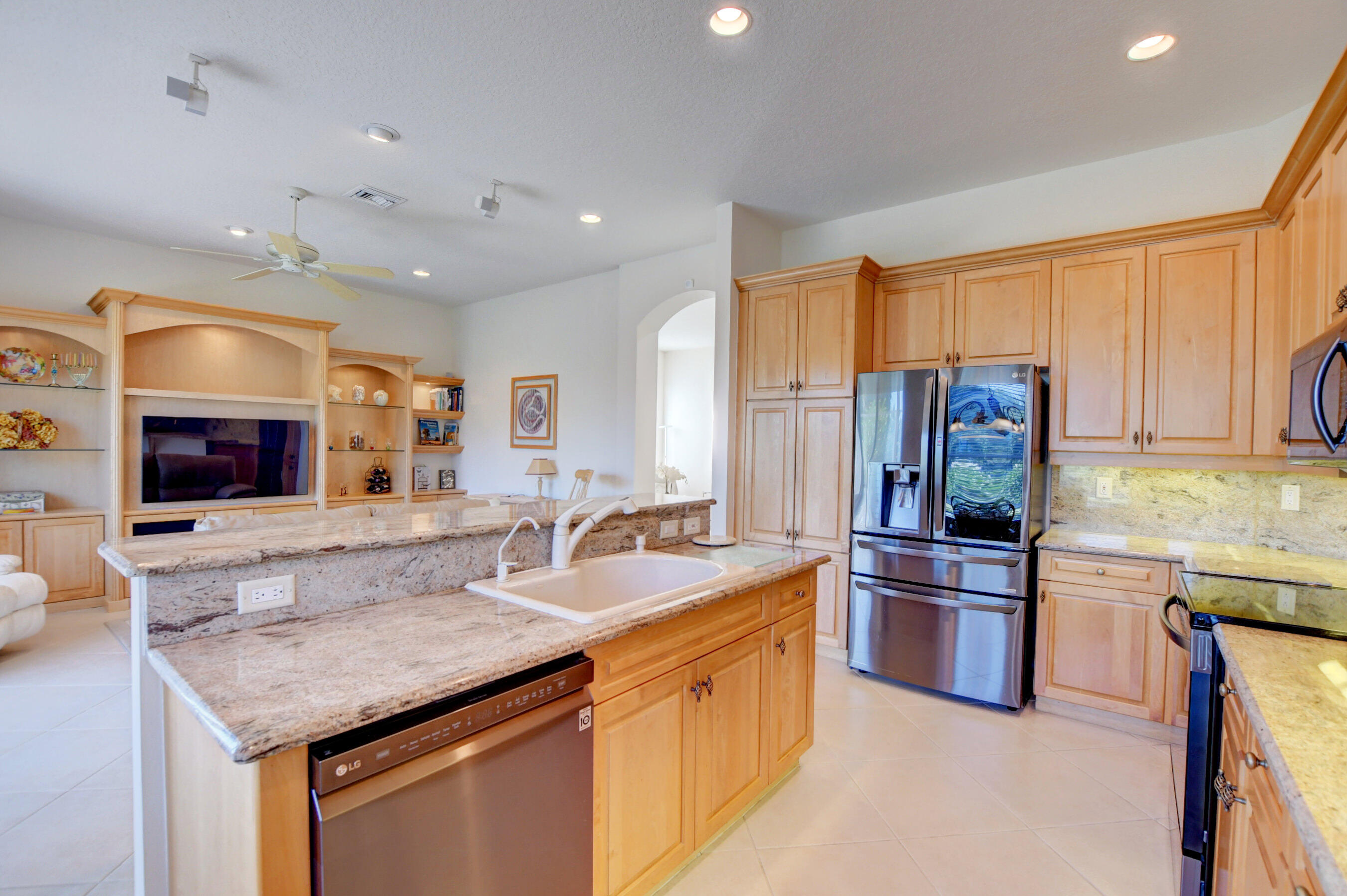 7097 Haviland Circle Boynton Beach, FL 33437 - Photo 9 of 72 a kitchen with stainless steel appliances granite countertop a sink stove and refrigerator