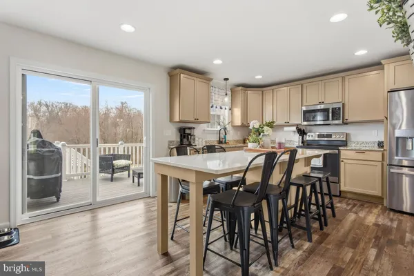 a kitchen with kitchen island wooden cabinets and counter space