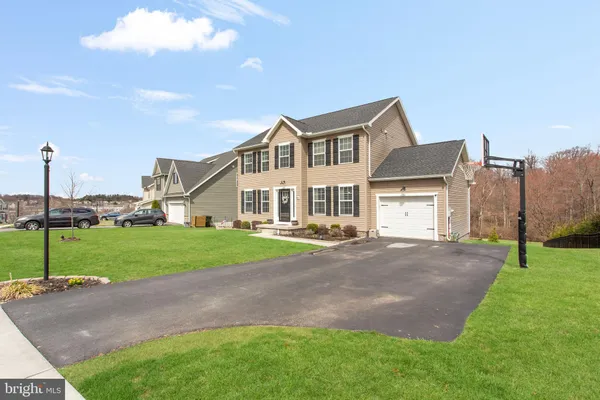 a front view of a house with a yard and garage