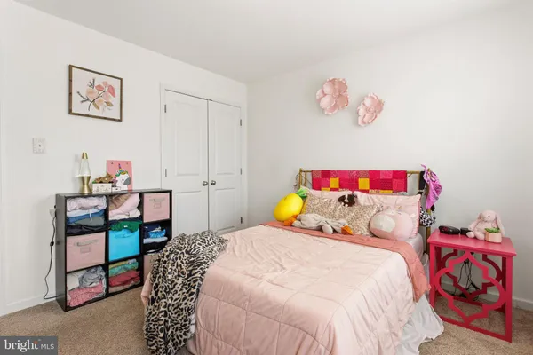 a bedroom with a bed and a workspace