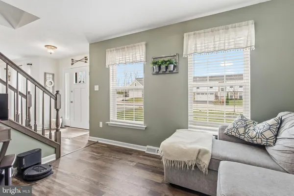 a spacious bedroom with a bed a couch and a window