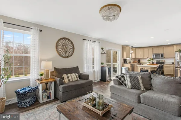 a living room with furniture a rug and a window