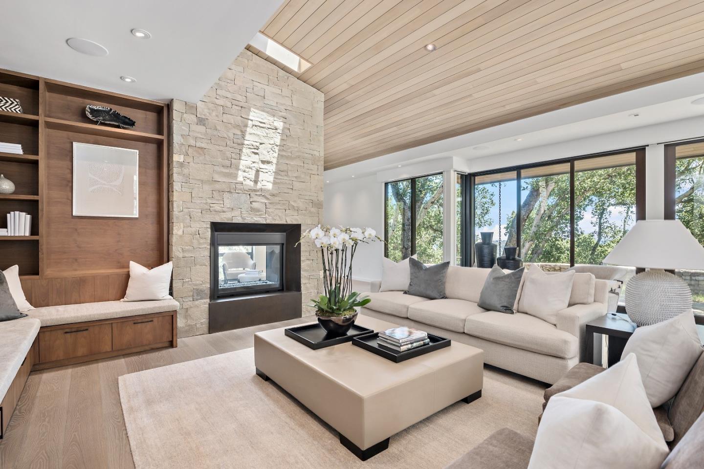 396 Raymundo Drive Woodside, CA 94062 - Photo 16 of 58 a living room with furniture a large window and a fireplace