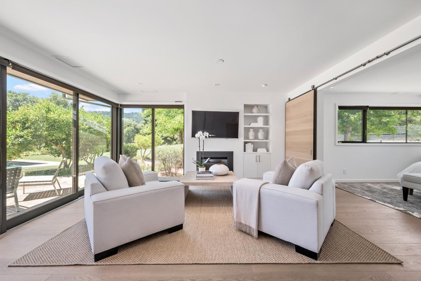 396 Raymundo Drive Woodside, CA 94062 - Photo 20 of 58 a living room with fireplace furniture and a large window