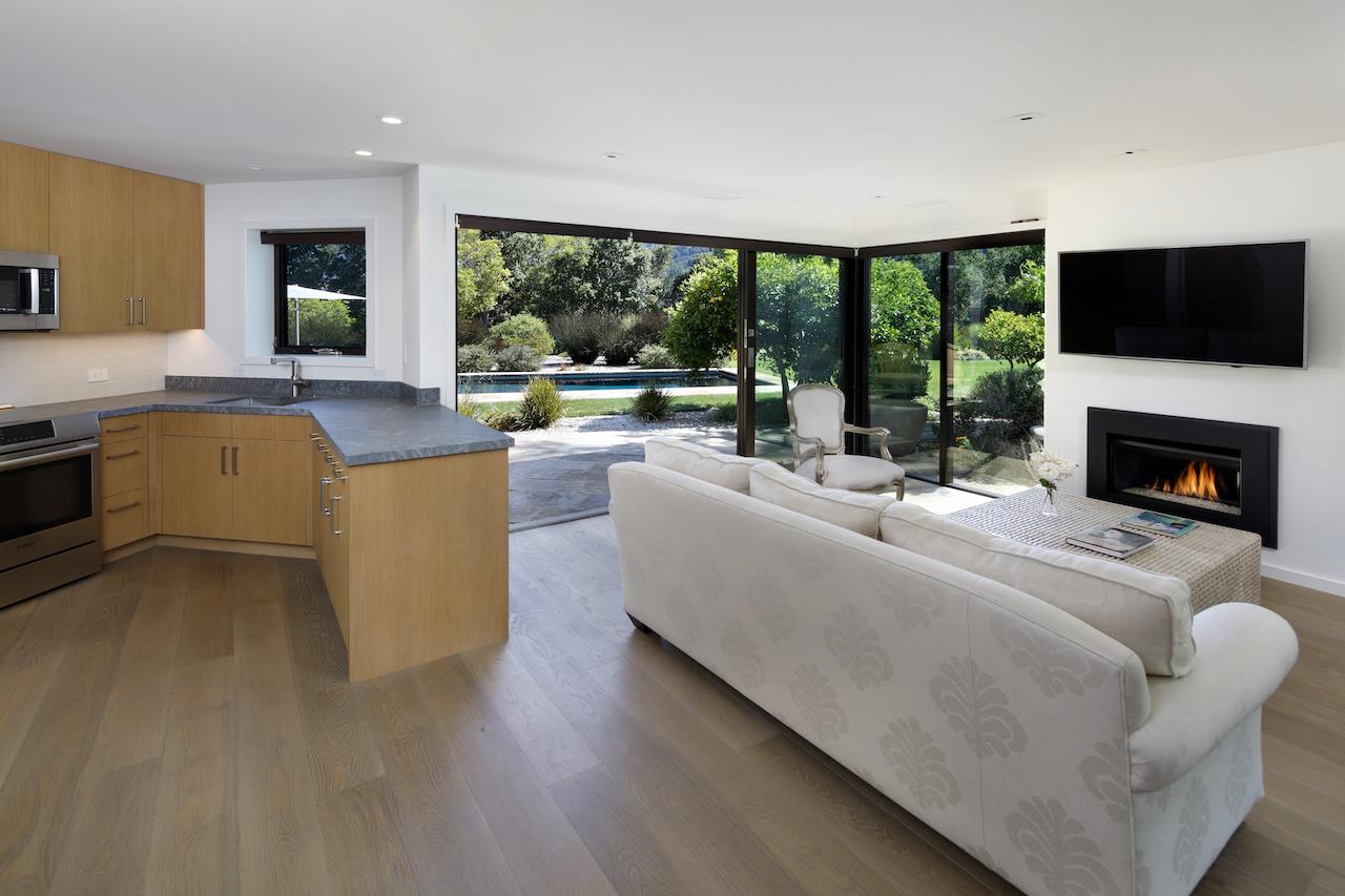 396 Raymundo Drive Woodside, CA 94062 - Photo 24 of 58 a living room with furniture a fireplace and a flat screen tv