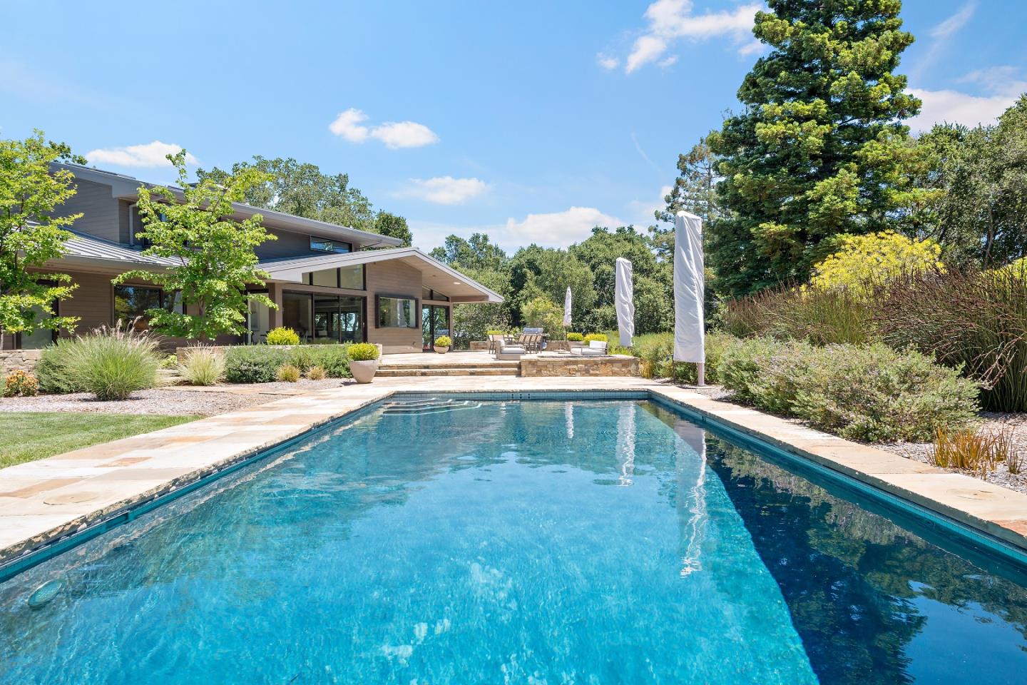 396 Raymundo Drive Woodside, CA 94062 - Photo 28 of 58 a view of a swimming pool with a patio