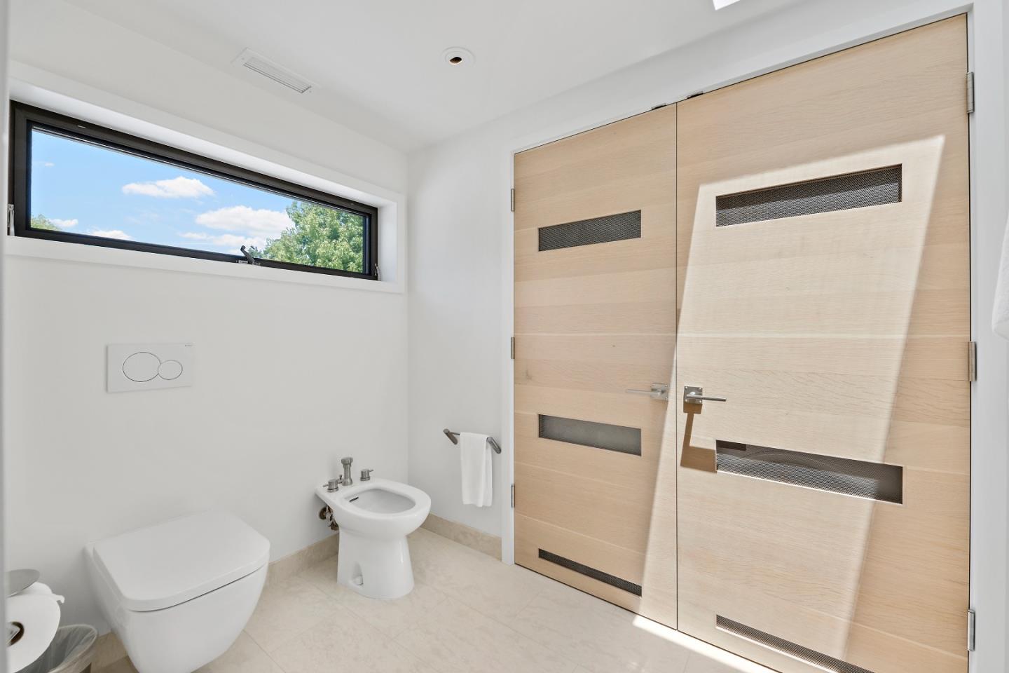 396 Raymundo Drive Woodside, CA 94062 - Photo 41 of 58 a white toilet sitting next to a bathroom sink