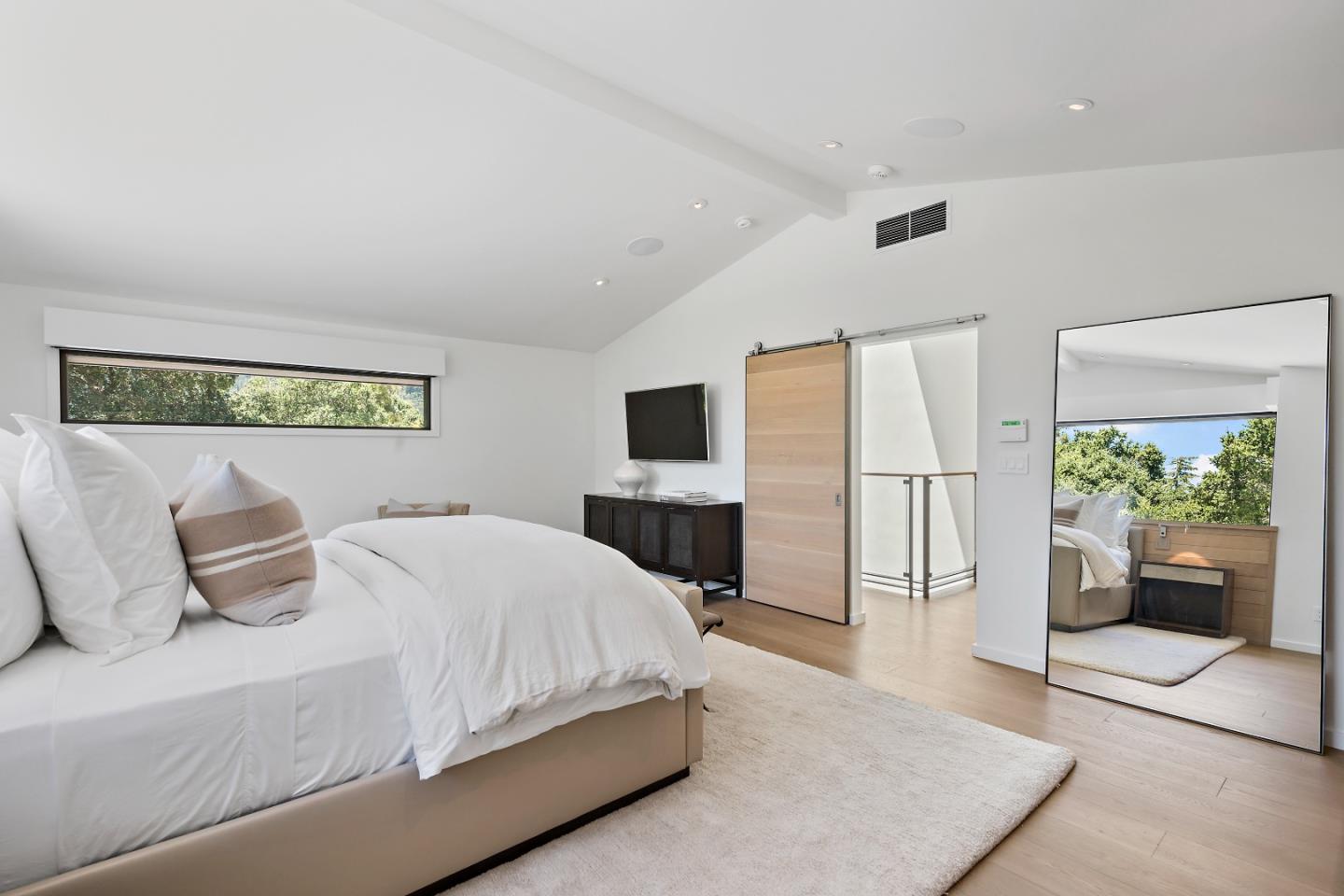 396 Raymundo Drive Woodside, CA 94062 - Photo 45 of 58 a bedroom with a large bed and flat screen tv