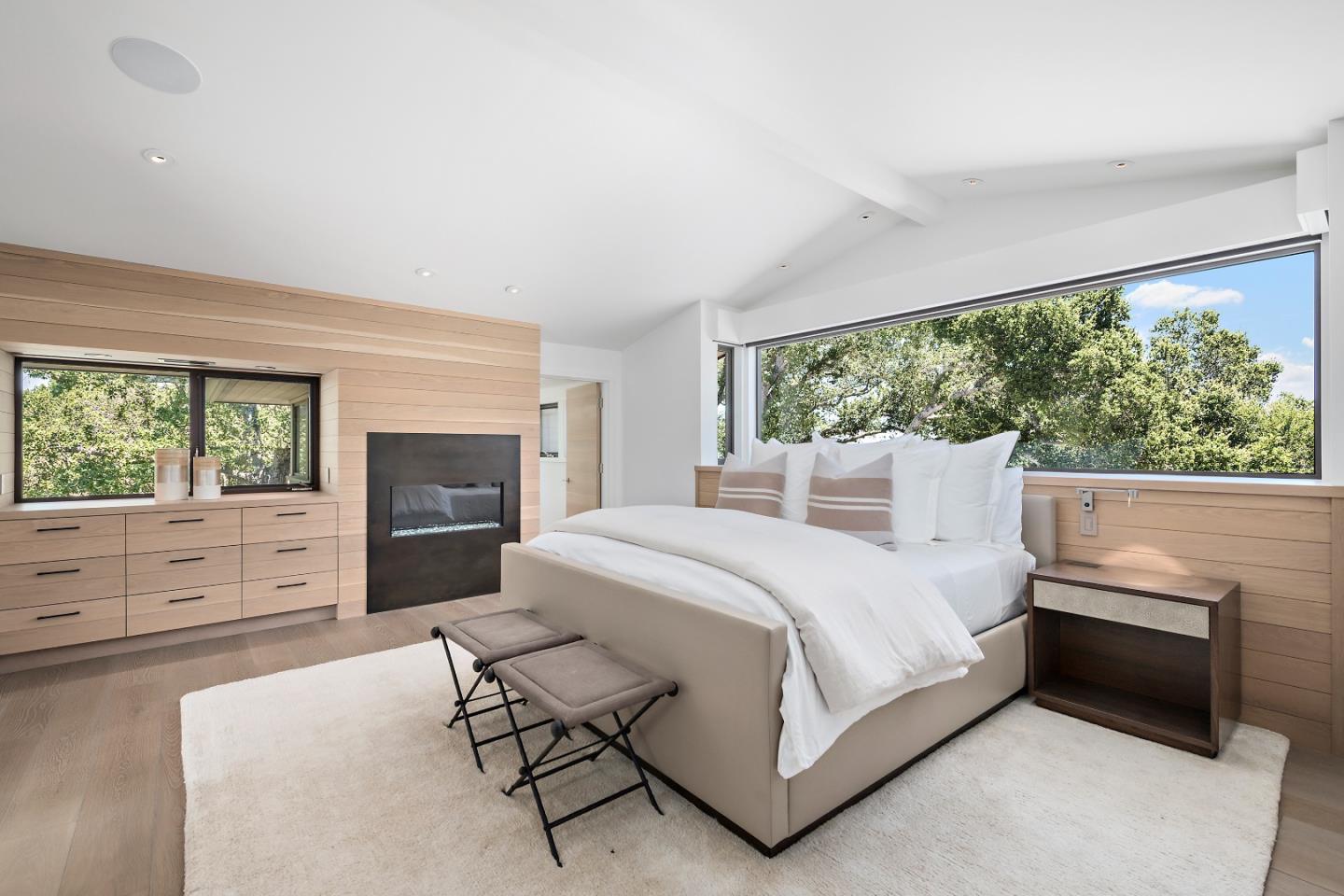 396 Raymundo Drive Woodside, CA 94062 - Photo 53 of 58 a bedroom with a bed and a fireplace