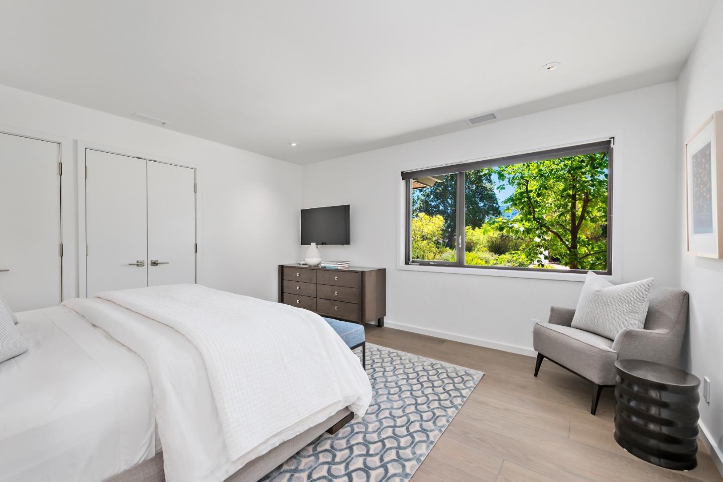 396 Raymundo Drive Woodside, CA 94062 - Photo 6 of 58 a spacious bedroom with a bed and a couch