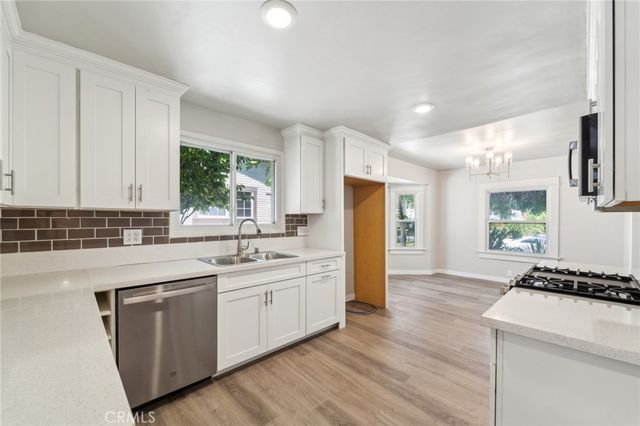 a kitchen with a sink stove and refrigerator