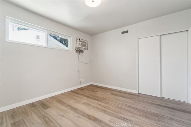 a view of a room with wooden floor and white walls