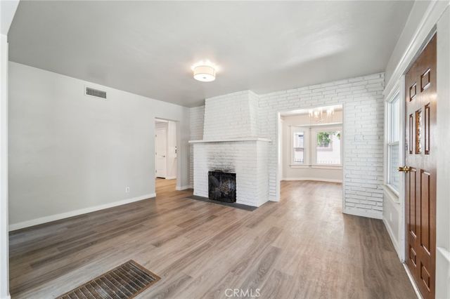 wooden floor fireplace and natural light in room
