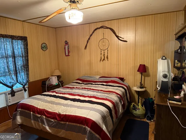 a bedroom with a bed a chandelier and a mirror