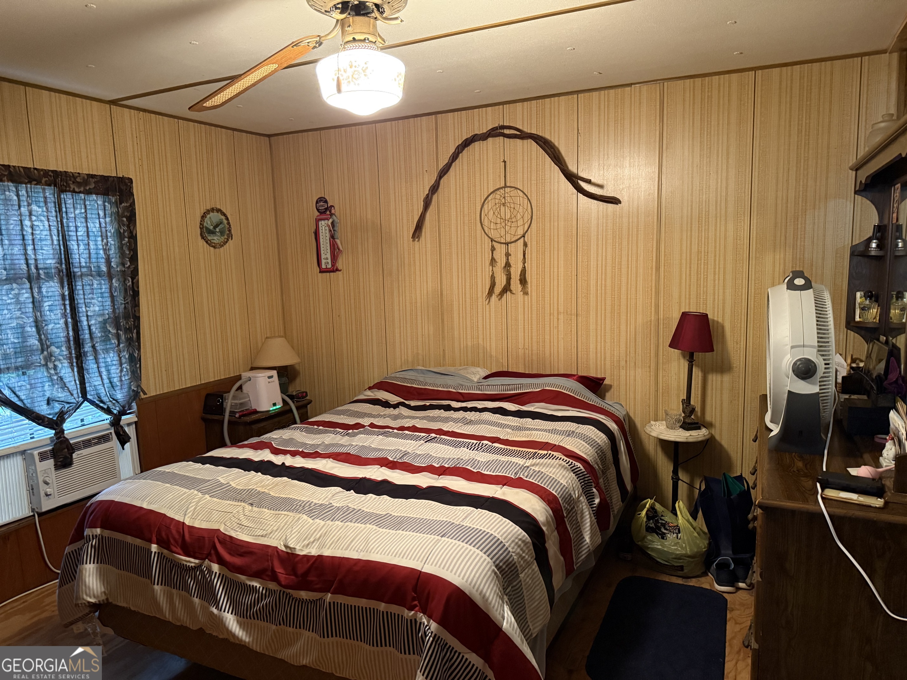 2387 5 Points Road Waco, GA 30182 - Photo 6 of 8 a bedroom with a bed a chandelier and a mirror