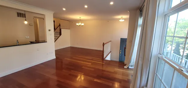 a view of entryway with furniture and wooden floor
